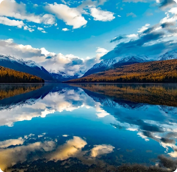 A body of water with mountains in the background